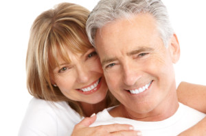 smiling couple with fixed dentures