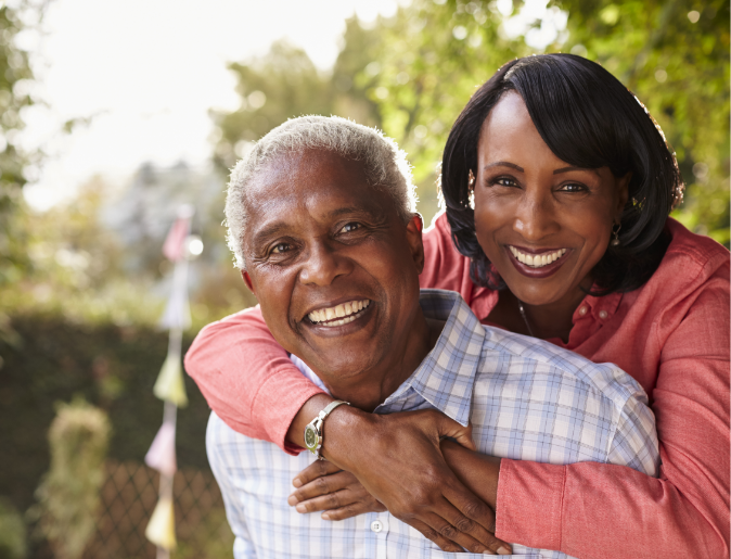 Senior couple in garden smiling
