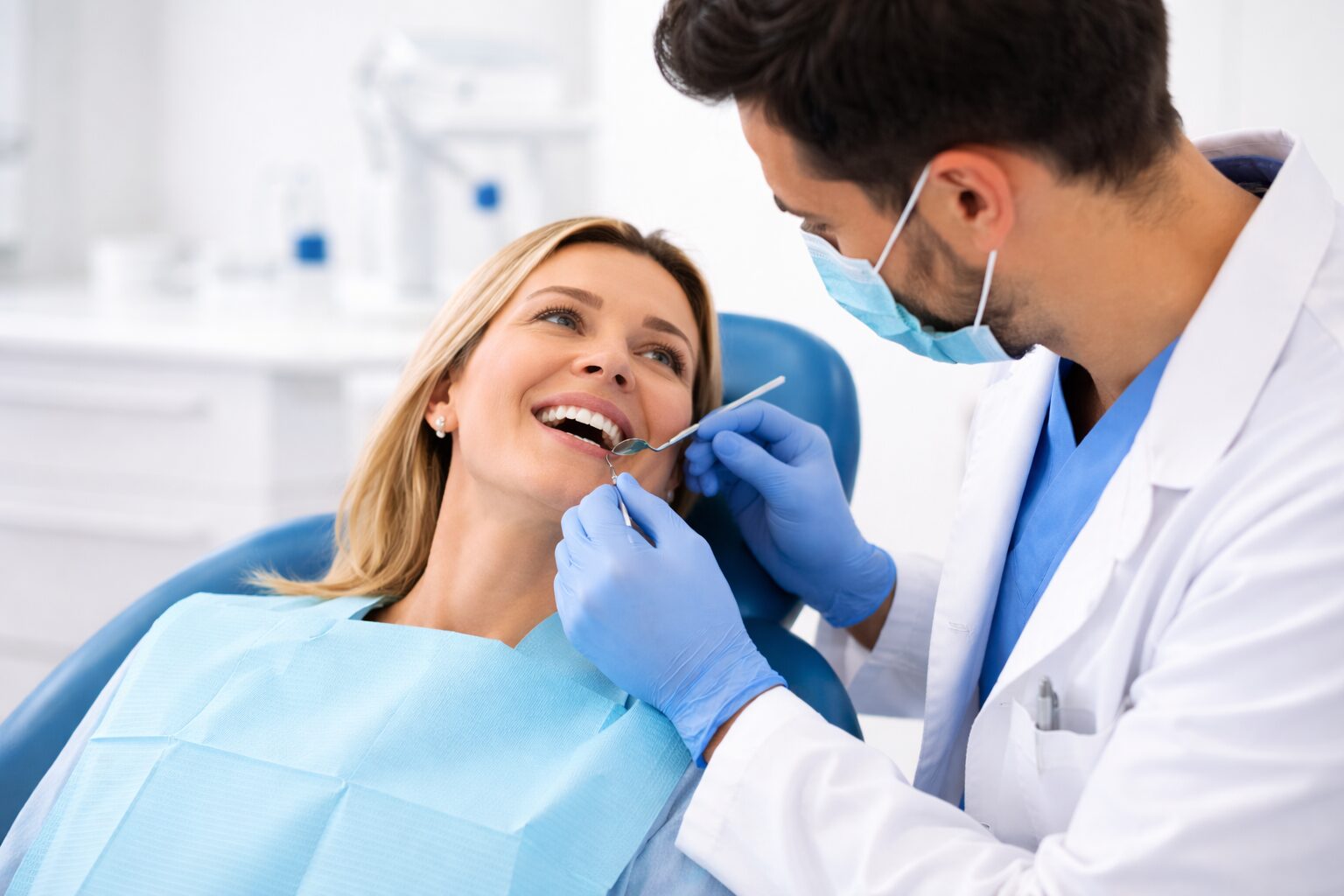 Dentist examining a patient’s gums during a preventive dental exam in Syosset, NY